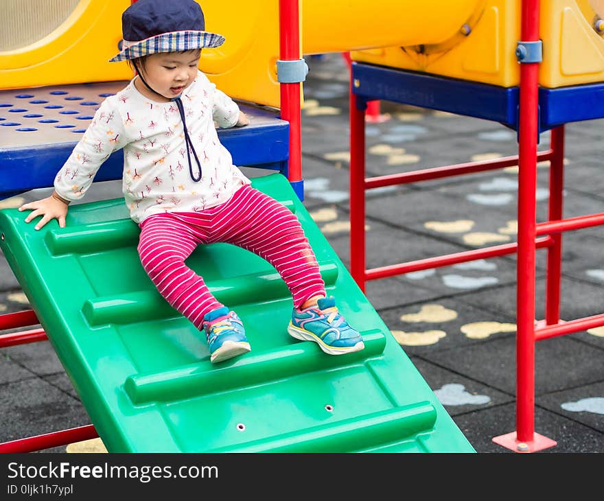 Happy little girl playing at the playground. Children, Happy, Family Concept.