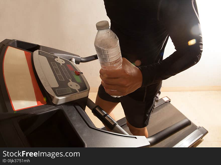 Man running on treadmill in fitness with water. Man running on treadmill in fitness with water