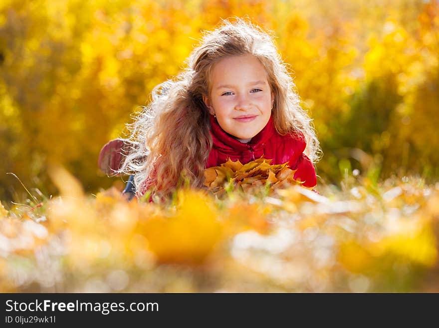 Girl at autumn. Child with leaf at park. Girl at autumn. Child with leaf at park