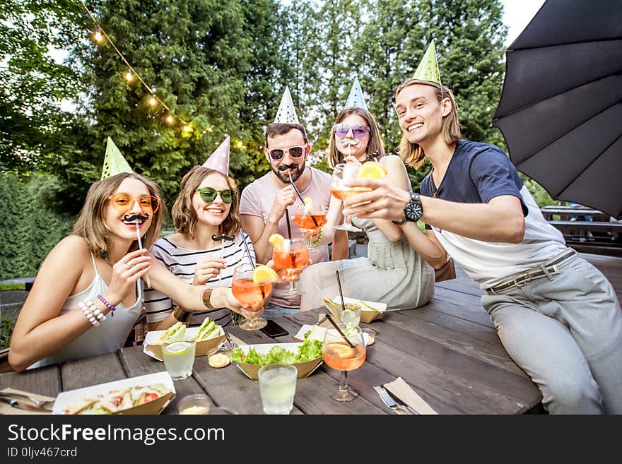 Friends having fun with photo booth outdoors