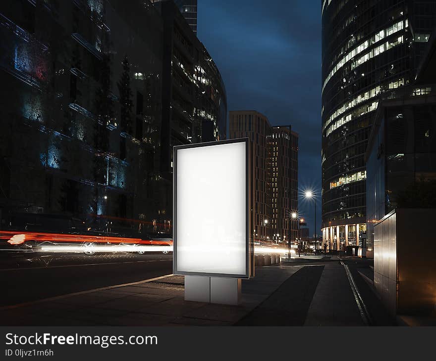 Blank illuminated banner at night time in the city. 3d rendering