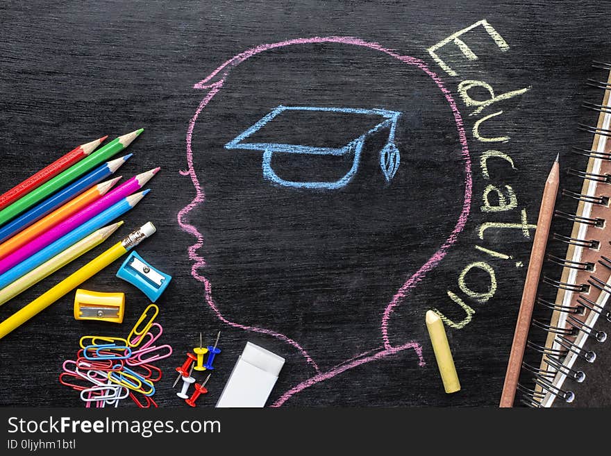 Children`s sketches aimed at success on a chalkboard with chalk and stationary. The concept of intelligence comes from education and back to school.