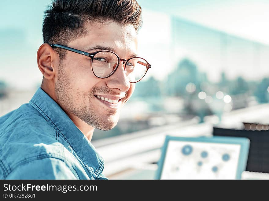 Portrait of delighted male person that posing on camera