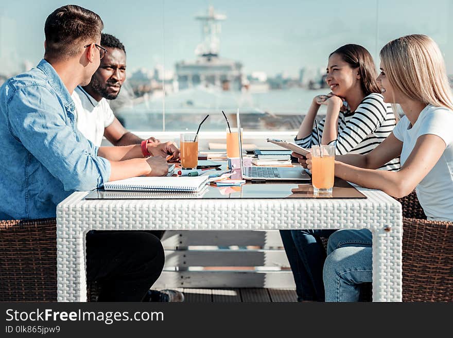 Group of students sitting on terrace