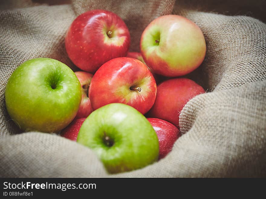 Harvest time, organics apples from nature in basket on sackcloth background texture. Harvest time, organics apples from nature in basket on sackcloth background texture