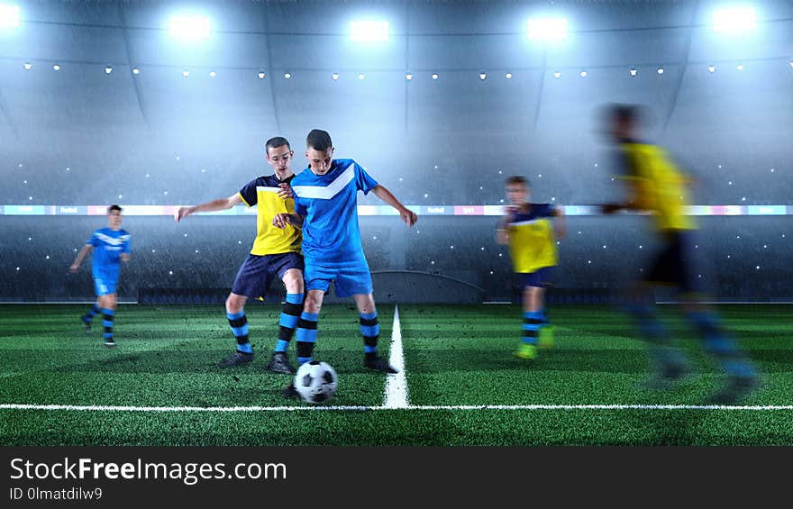 Young soccer players in action on the soccer stadium. Crowd and stadium made in 3D. Young soccer players in action on the soccer stadium. Crowd and stadium made in 3D