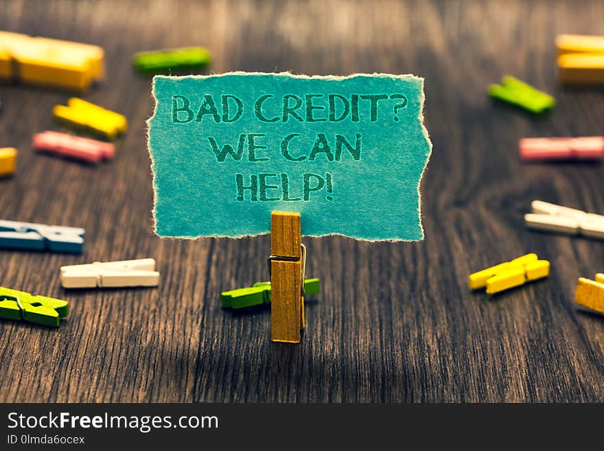 Conceptual hand writing showing Bad Credit question We Can Help. Business photo showcasing Borrower with high risk Debts Financial Paperclip retain blue cardboard blurry woody desk paper clip