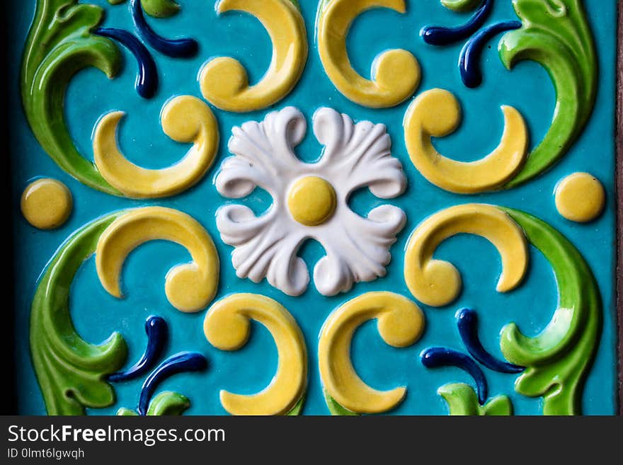 Different shapes and colorful pattern on the wall. The pattern is very old and belongs to the architecture of the seventeenth century. The pattern attracts attention with its beauty.