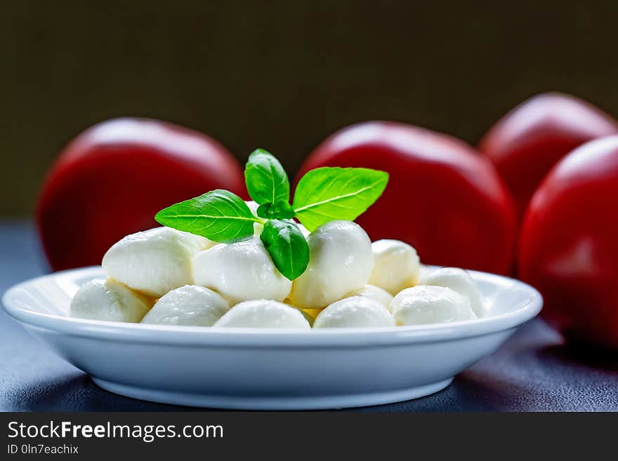 Mozzarella, red tomatoes and fresh Basil on a black background. top view. Flat lay. Food concept. Healthy and wholesome food.