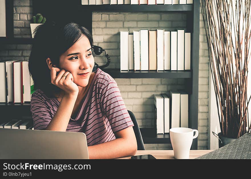 Happy business woman relaxing in office