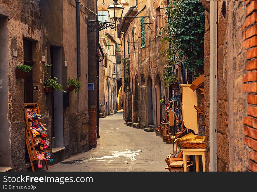 Narrow street of medieval ancient tuff city Pitigliano, travel Italy background. Narrow street of medieval ancient tuff city Pitigliano, travel Italy background