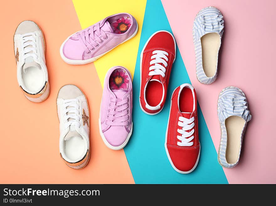 Flat lay composition with stylish new shoes on color background