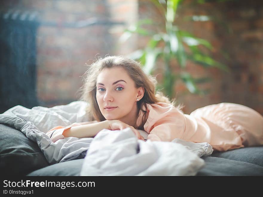 Morning leisure. Woman is lying on the bed. Morning leisure. Woman is lying on the bed