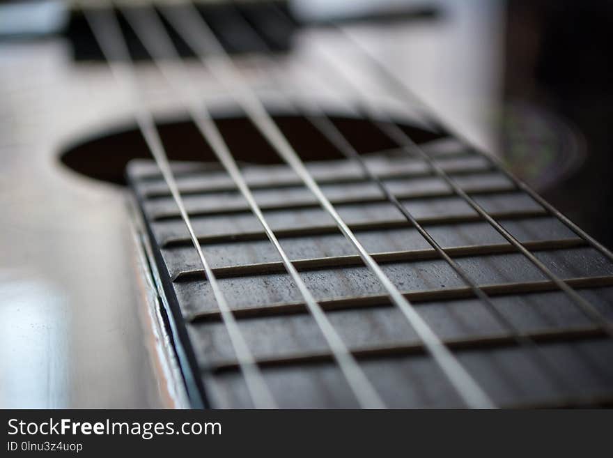 Detail of classic acoustic guitar with shallow DOF and blur.