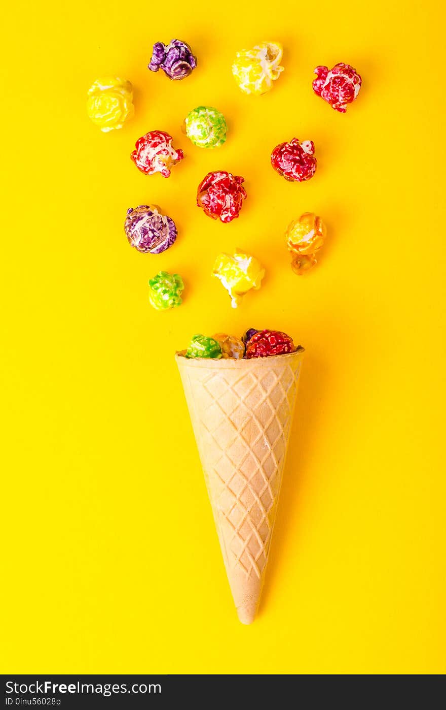 Sweet colored popcorn on bright background. Studio Photo