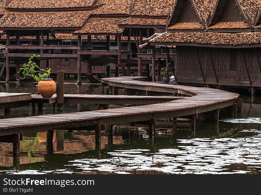 Peaceful thai floating architecture with traditional wooden house and bridge in Ancient City