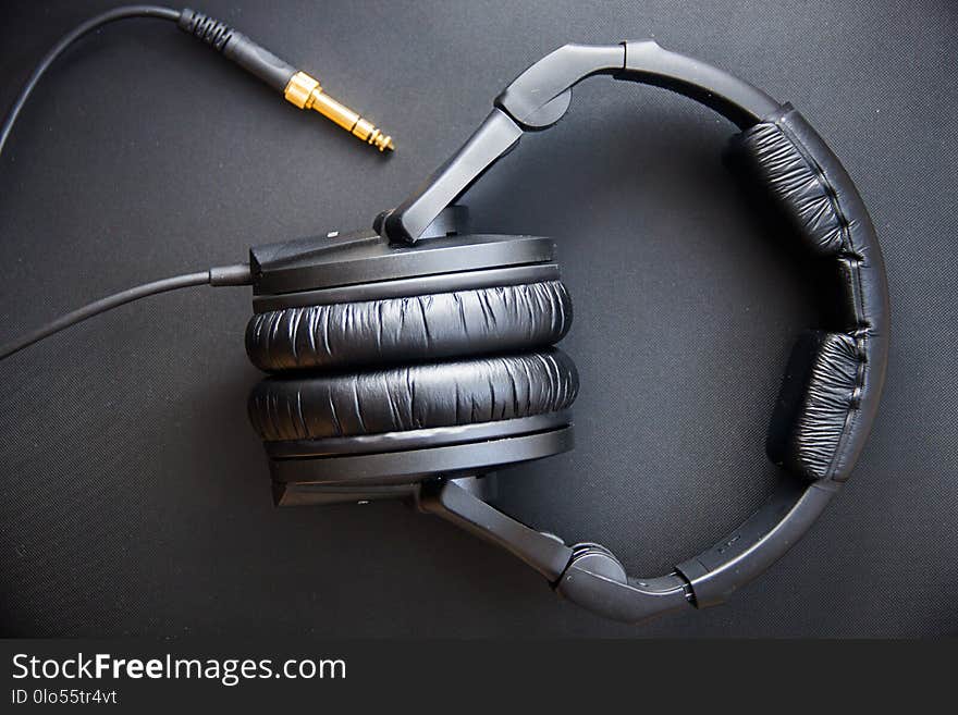 Musical equipment, Professional studio black headphones and jack cord. View from above.