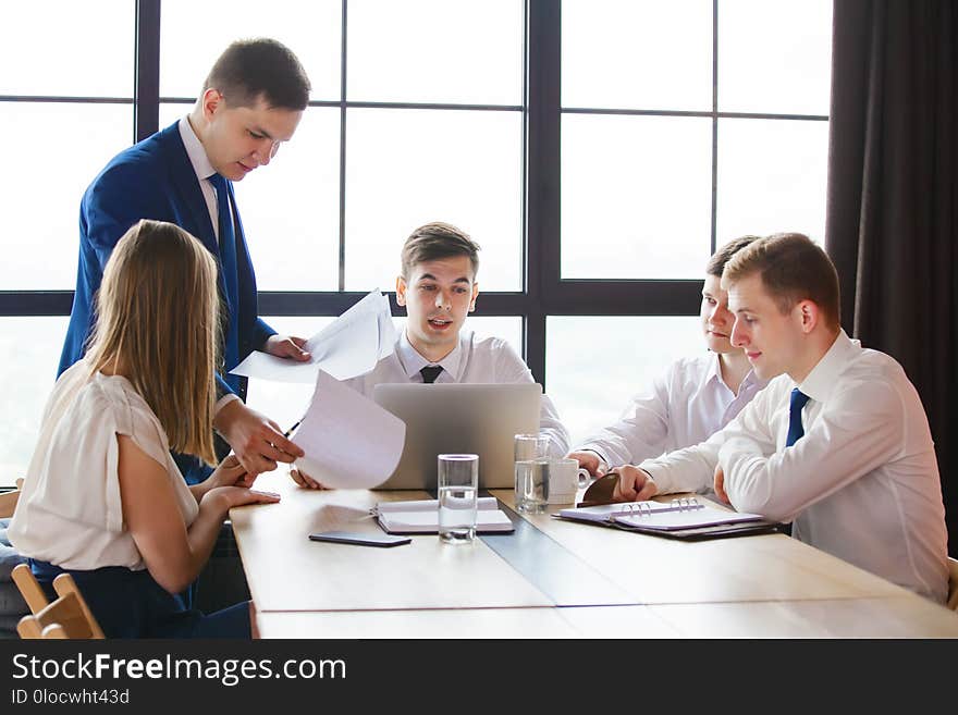 Group of young business team working at a table. Group of young business team working at a table