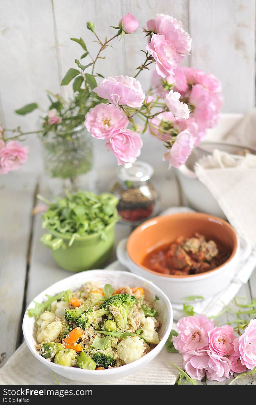 A lunch of vegetable salad, on a table with a bouquet of garden roses. Food for vegetarians. Wessen Lunch.