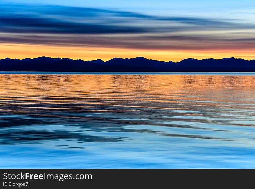 Beautiful gold and orange sunset above the sea and mountain. Beautiful gold and orange sunset above the sea and mountain