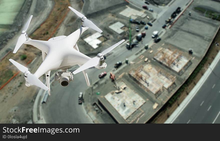 Unmanned Aircraft System UAV Quadcopter Drone In The Air Over Construction Site. Unmanned Aircraft System UAV Quadcopter Drone In The Air Over Construction Site.