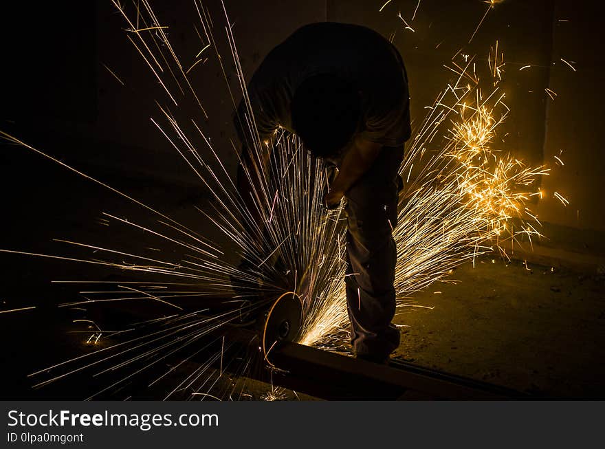 Men at work grinding steel.