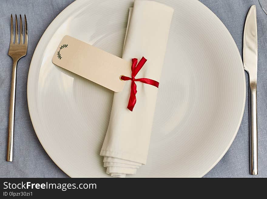 Knife, fork, plate and napkin in restaurant