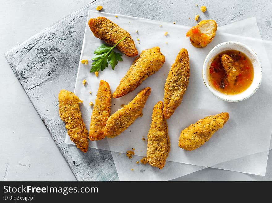 Chicken breast nuggets with sour sweet sauce on white background top view. Chicken breast nuggets with sour sweet sauce on white background top view