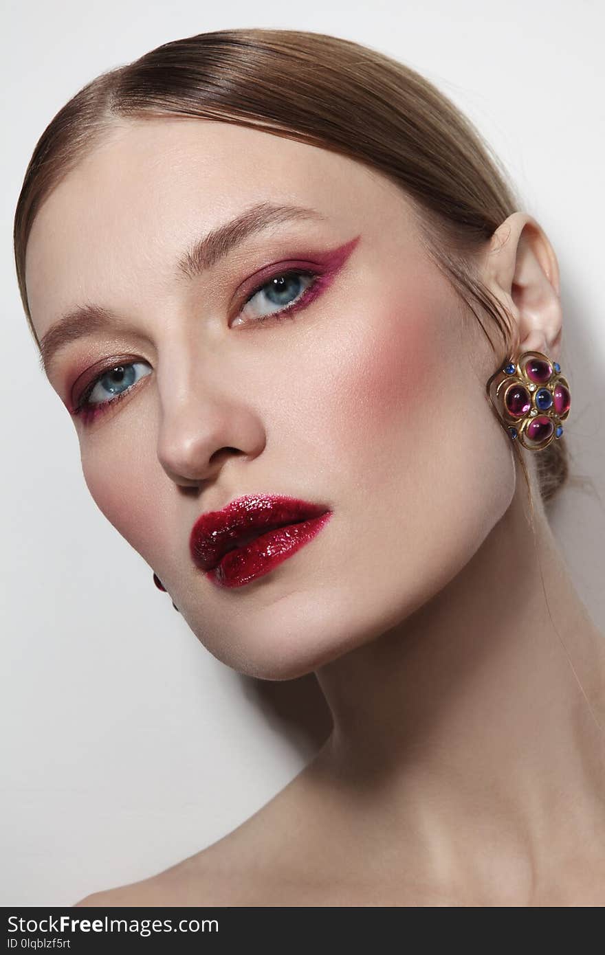 Close-up glamorous portrait of young beautiful woman with winged eye make-up