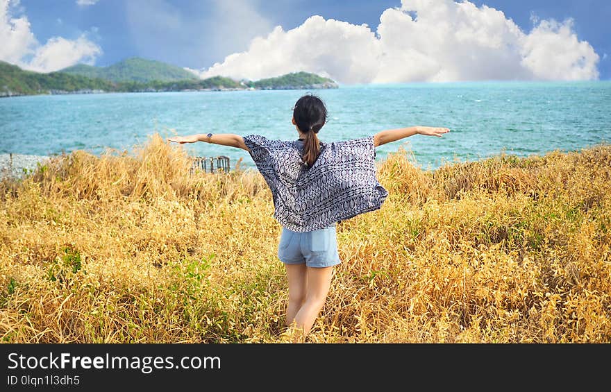 Young woman relaxing with meadow, sea, mountain, blue sky and cloud at Koh Sichang in Thailand, Space for text in template, Travel concept, Many tourists visit here, View for seascape. Young woman relaxing with meadow, sea, mountain, blue sky and cloud at Koh Sichang in Thailand, Space for text in template, Travel concept, Many tourists visit here, View for seascape