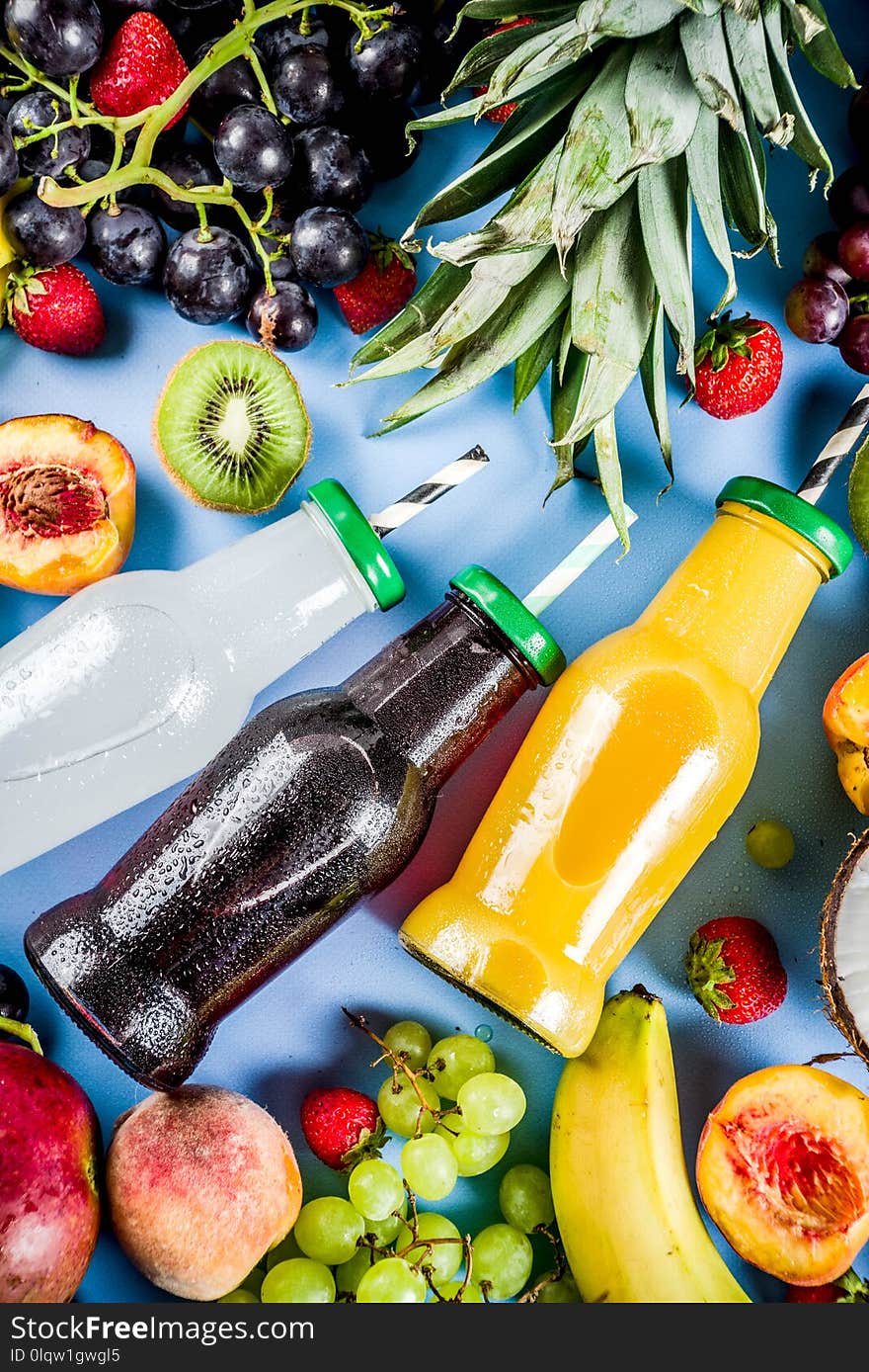 Different fruit juices smoothies concept, summer vitamins diet, with tropical fruits and berries on a light background,. Different fruit juices smoothies concept, summer vitamins diet, with tropical fruits and berries on a light background,