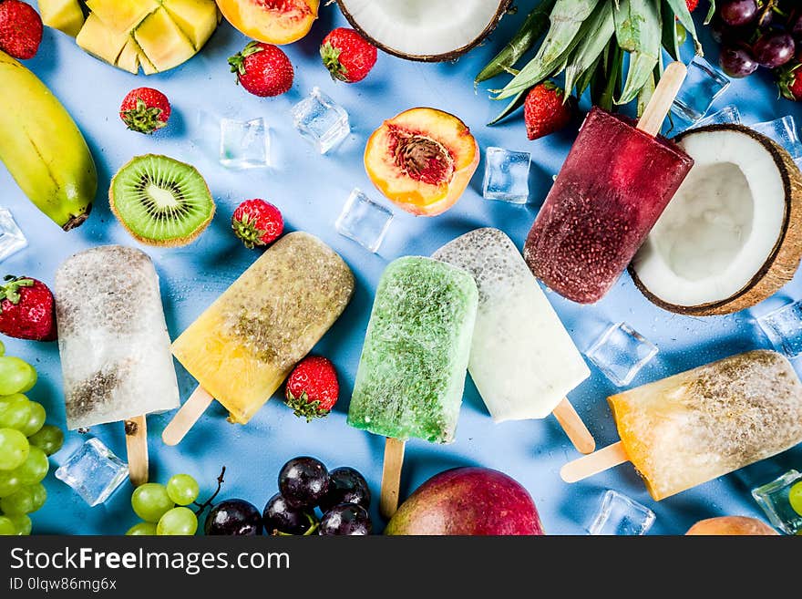 Tropical ice cream popsicles with chia seeds and fruit juices - pineapple, orange, mango, banana, kiwi, coconut, grapes, peach, strawberry, copy space. Tropical ice cream popsicles with chia seeds and fruit juices - pineapple, orange, mango, banana, kiwi, coconut, grapes, peach, strawberry, copy space