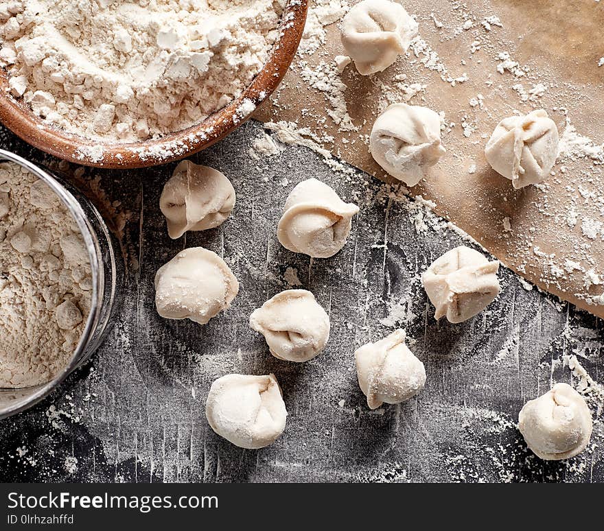 Raw russian dumplings with flour on table