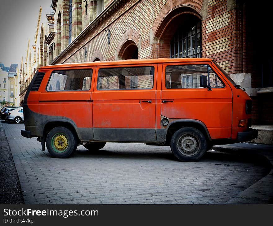 Old European orange camper in urban setting