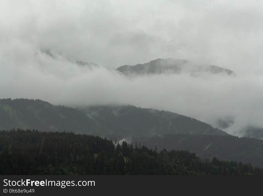 View on clouded and grey Ennstaler Alps as seen from the Hauser Kaibling mountain on a rainy morning hike.