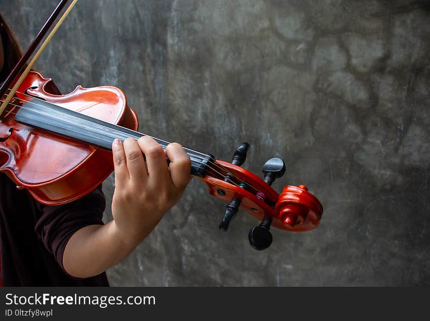 Closeup photo of Violinist playing the violin.