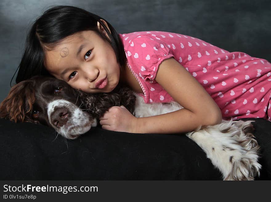 Child and dog: girl with her favorite pet shot indoor in studio