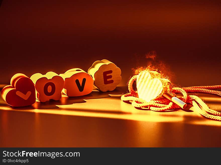 Love is fire concept : The word love on the wooden floor