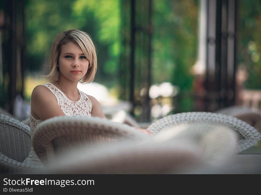 Portrait of a beautiful young woman at a table in a cafe