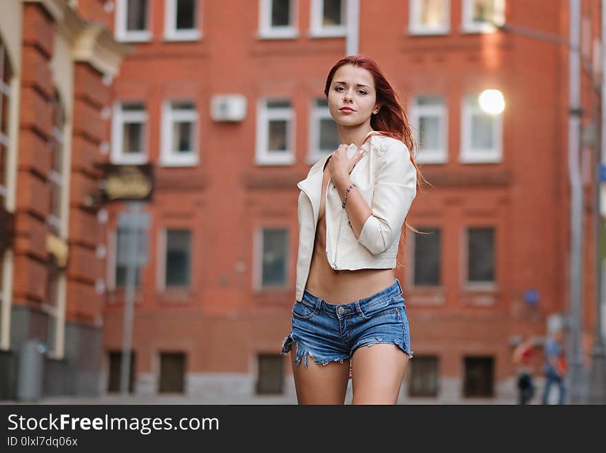 Hot redhair woman in the city. Half naked girl. Fashion art photo.