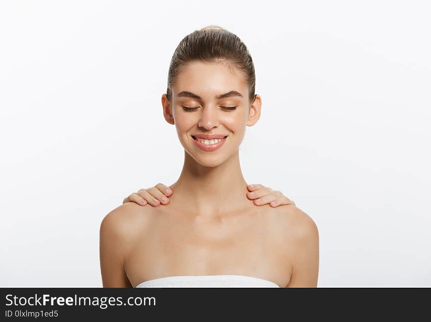 Beautiful young woman relaxing with hand massage. Isolated on white background.