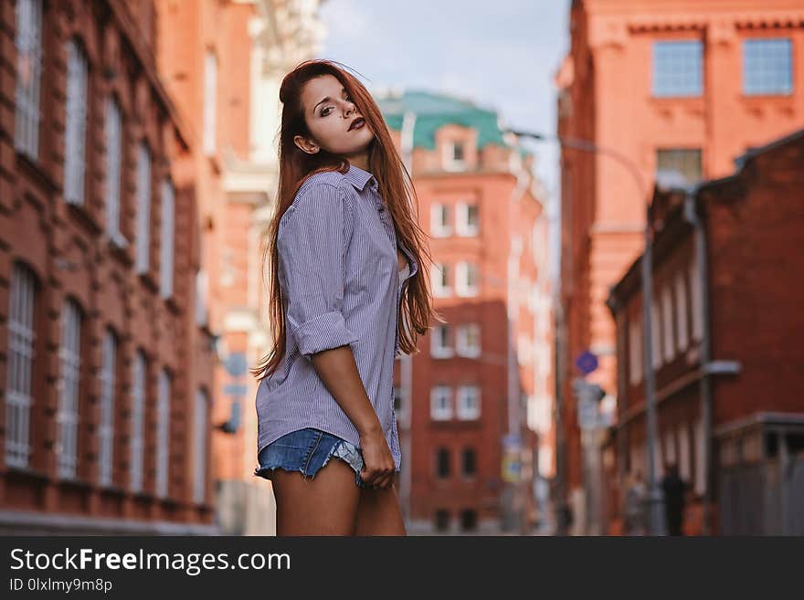 Fashion Art Photo. Portrait Of Woman With Long Red Hair, In The City.