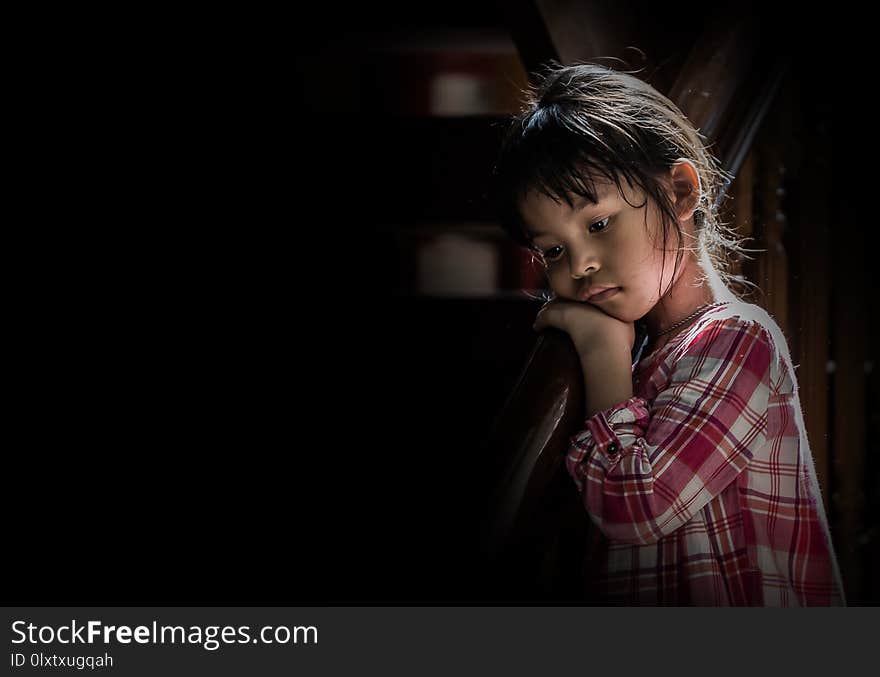 Asian girl is sad in black background