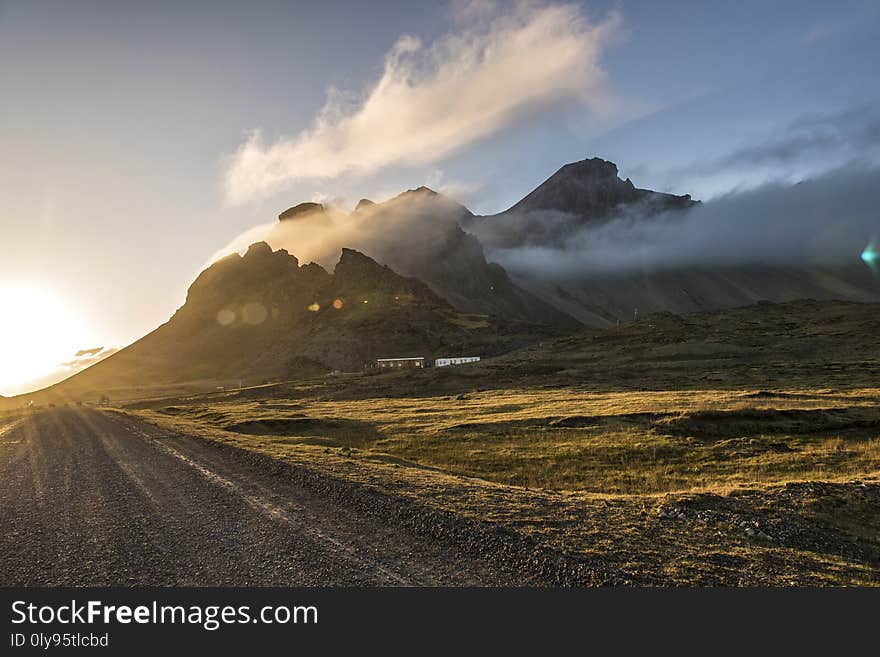 Sunset in Stokksnes, Iceland with Vestrahorn mountain visible, partially obscured by clouds. Sunset in Stokksnes, Iceland with Vestrahorn mountain visible, partially obscured by clouds.