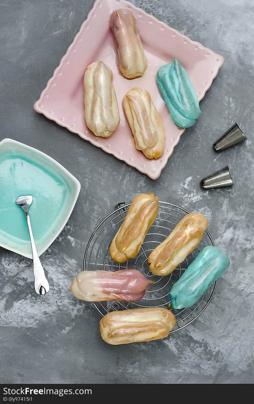 Eclairs with color glaze on gray background