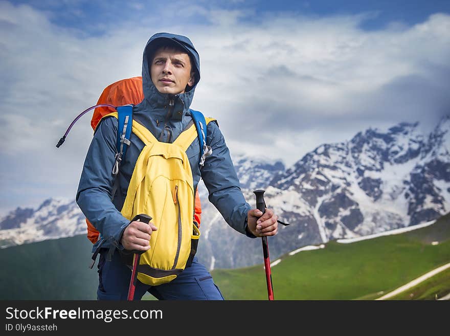 Portrait of hiker in mountains in sportswear. Tourist is on hiking trek. Adventure hike along hills and mountains