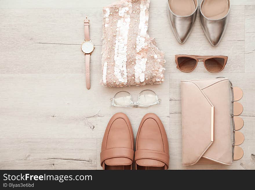 Flat lay composition with stylish female outfit and space for text on wooden background