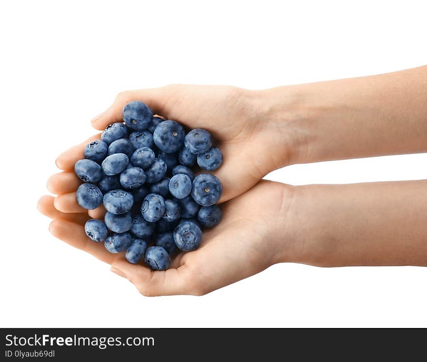 Woman holding fresh ripe blueberries on white background, closeup view