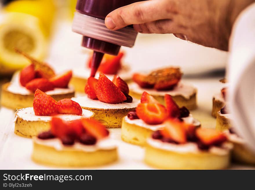 The chef in the kitchen prepares strawberry desser