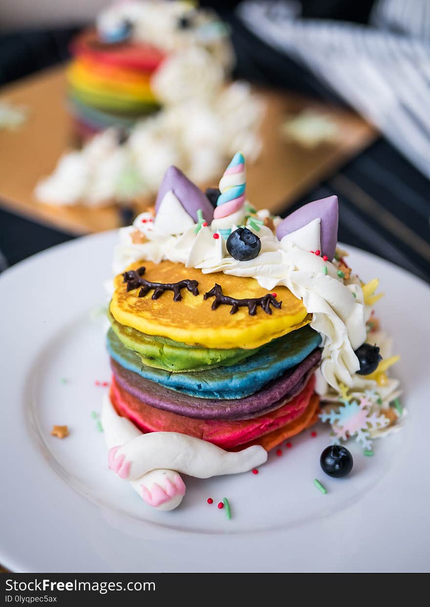 Fresh baked cute unicorn Rainbow Pancake with buttercream berry and decorate sugar. kids meal. Fresh baked cute unicorn Rainbow Pancake with buttercream berry and decorate sugar. kids meal.